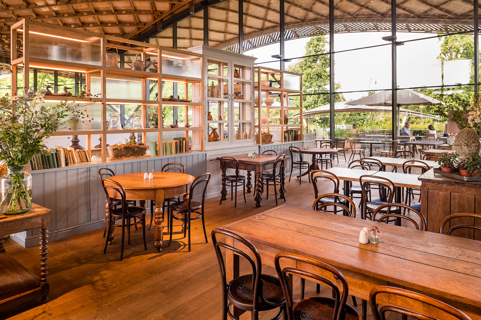 A blend of reclaimed and off-the-shelf tables amongst the dressers with a clear sightline to The Savill Garden.