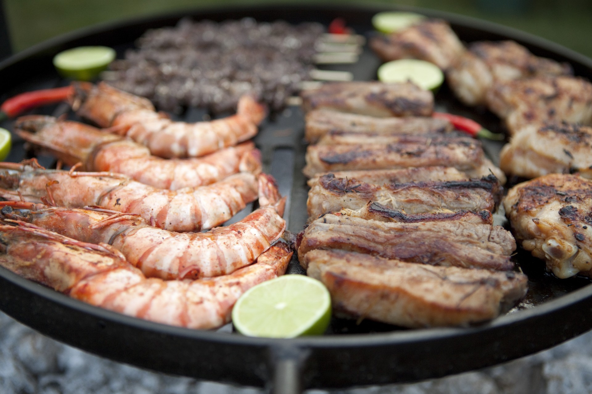 A barbecue of prawns, beef, and pork.