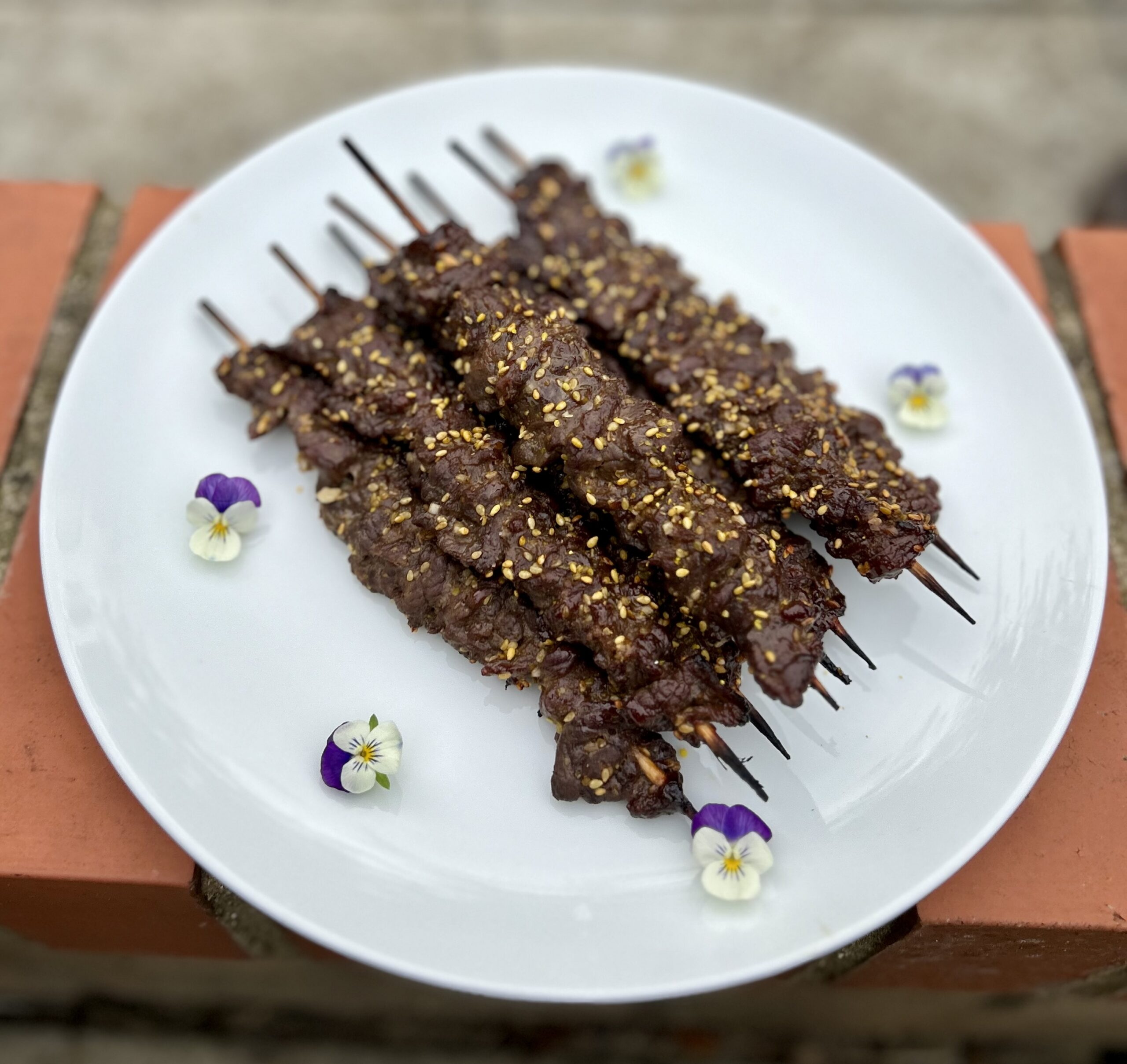 Strips of barbecued beef on skewers.