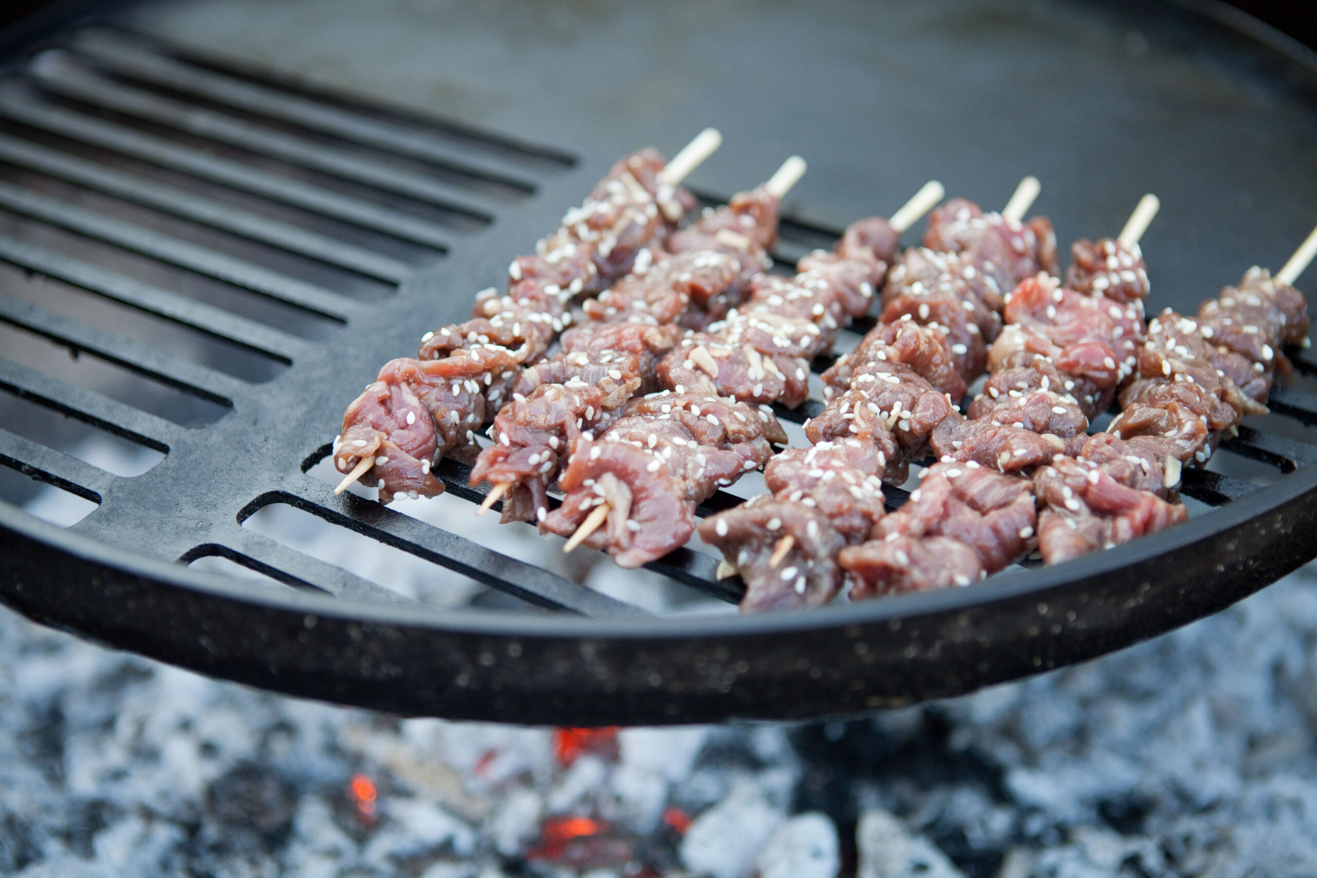 Beef skewers on a BBQ.