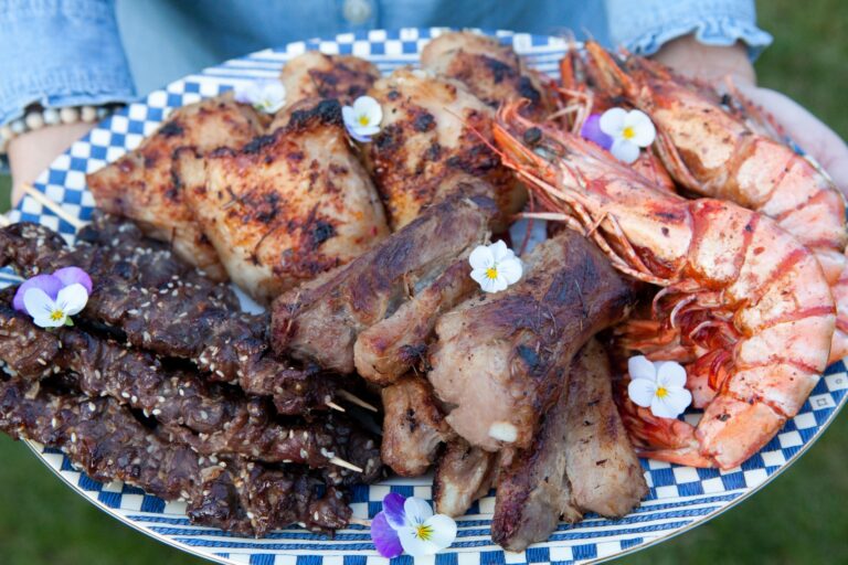 A plate of barbecued meats and prawns