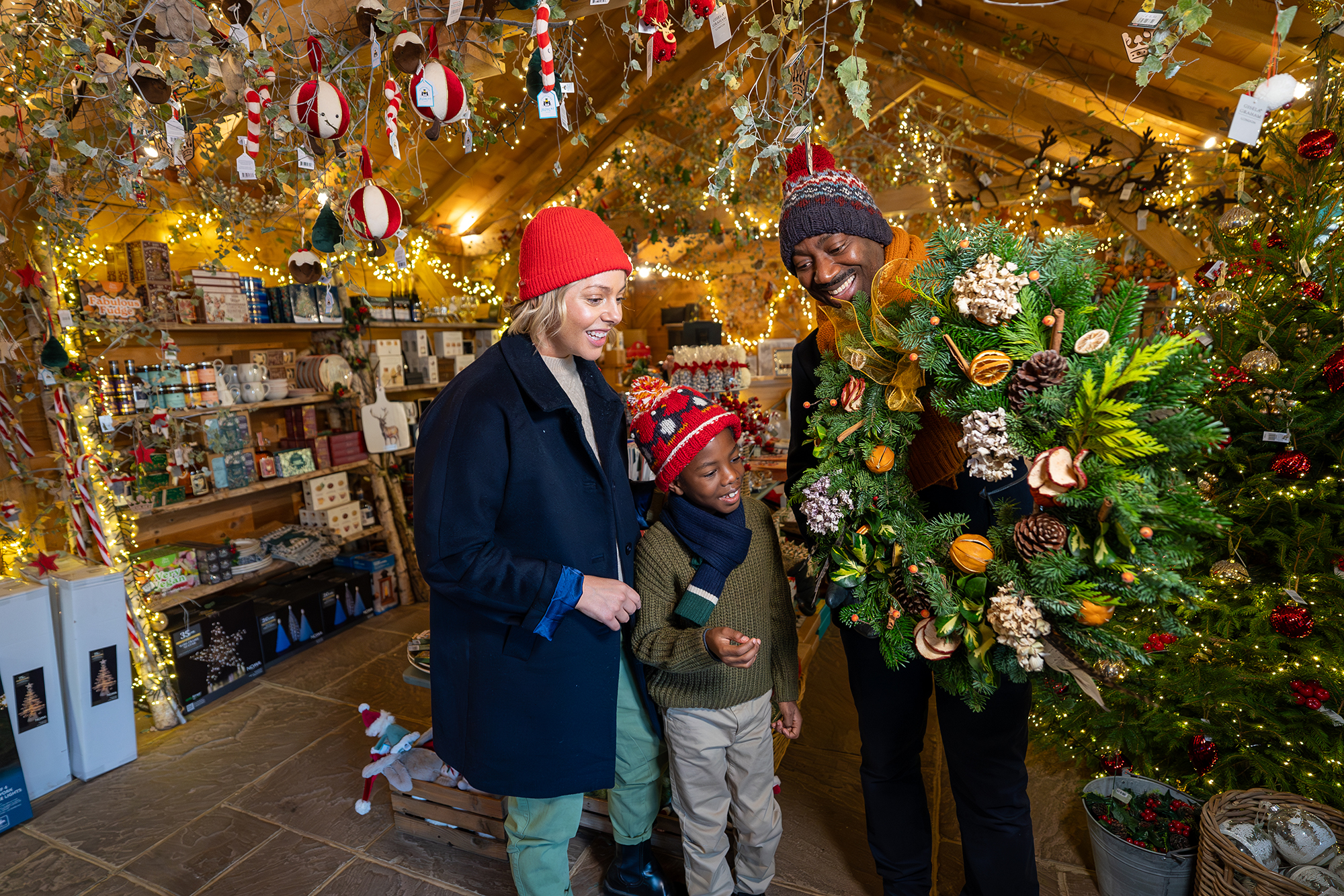Family from multi-ethnic background looking at a Christmas wreath at the Windsor Great Park Christmas Tree Shop.