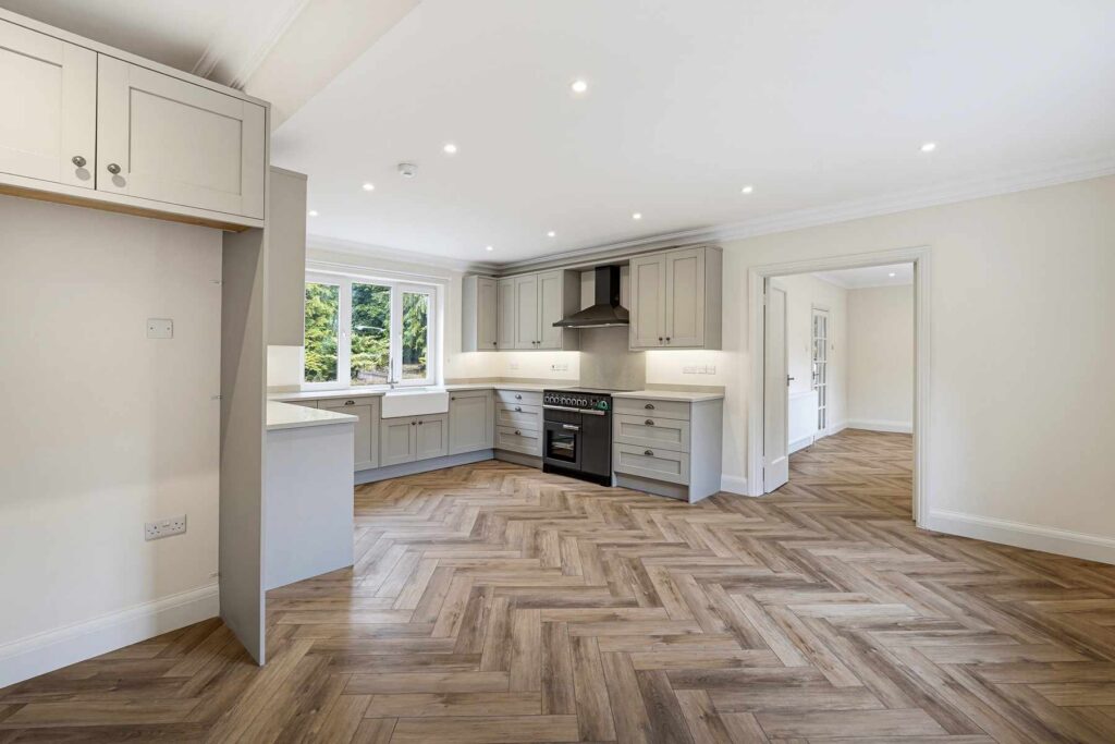 Open-plan kitchen and dining room with shaker-style cabinetry and range-style cooker.