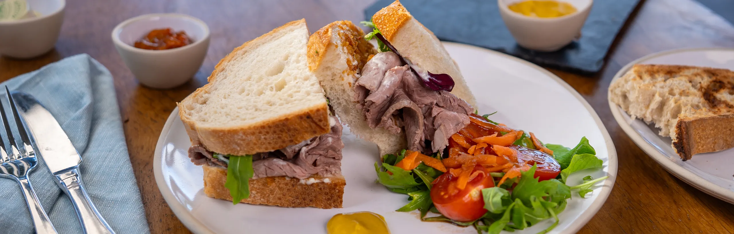 Windsor Farms beef sandwich with a side salad.